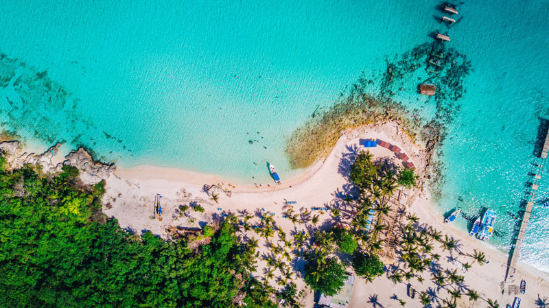 Two kids fishing a sinking boat. Saona island, Dominican Republic